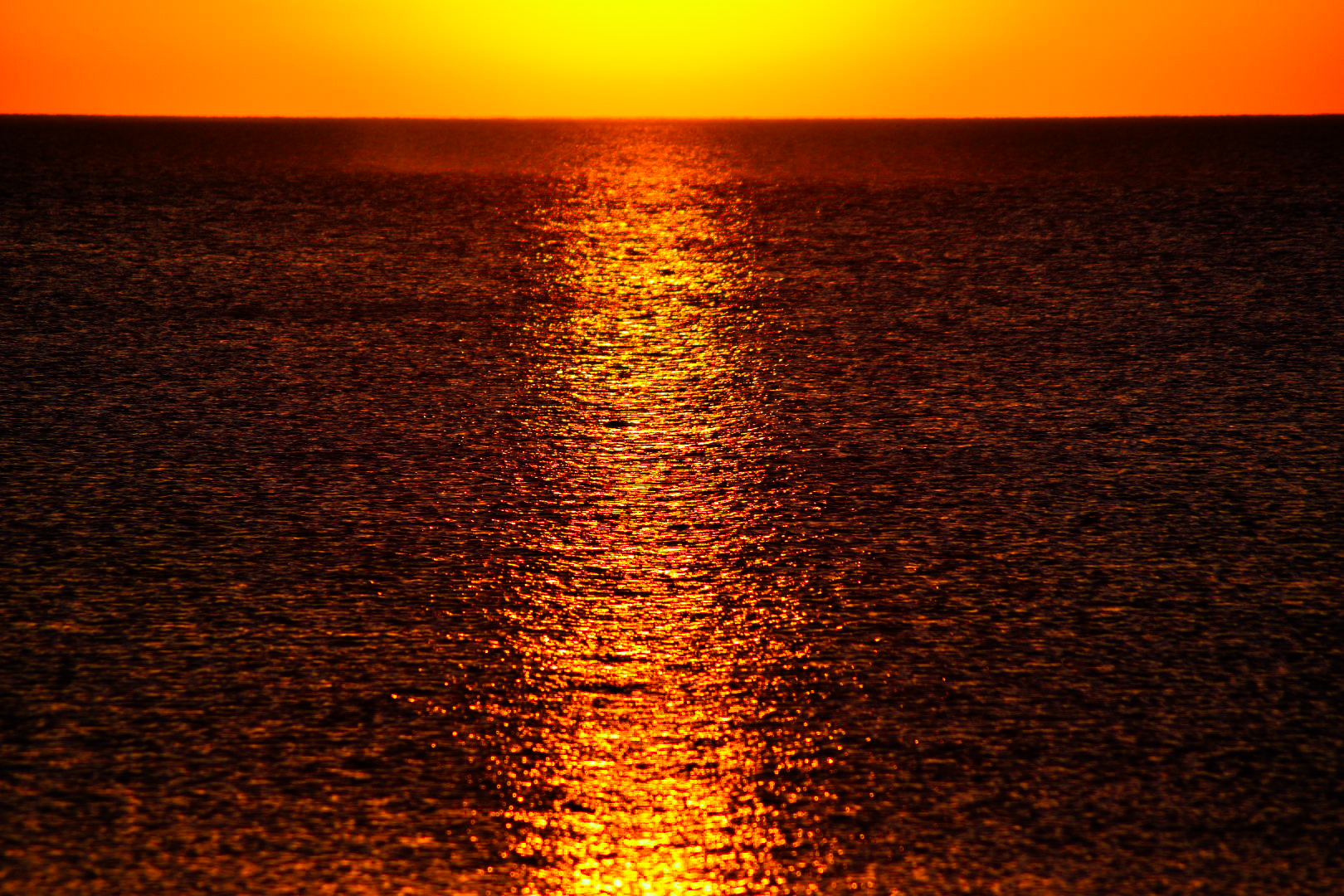 Sunset light stretching across open water
